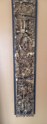 a picture of a metal wall hanging with a clock on it