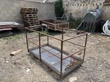 a small metal structure in the middle of a dirt field