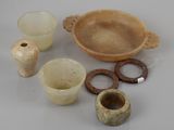 several pieces of pottery sitting on top of a table next to each other