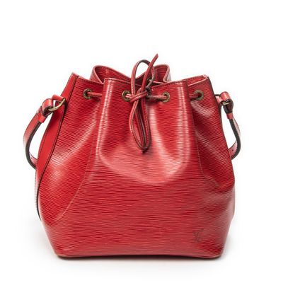 a red louis vuitton bucket bag on a white background