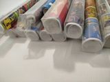 a lot of rolls of wrapping paper sitting on a table