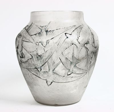 a glass vase with a design on it on a white surface