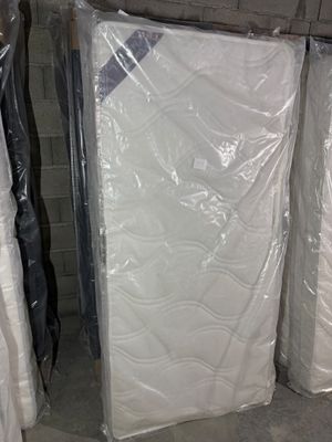 many mattresses that are wrapped up in plastic