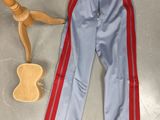 a pair of pants and a guitar on the floor