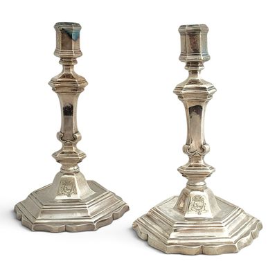 pair of silver candlesticks on a white background