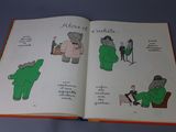 an open book with pictures of people and animals on it