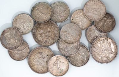 a pile of old coins on a white surface