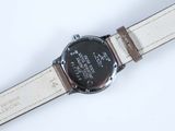 a close up of a watch on a white surface