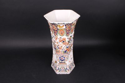 a vase with a floral design on it on a black background