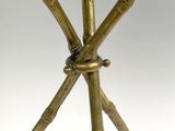 an image of a brass table with four legs and a glass top