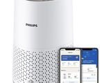 the philips smart air purifier is next to an iphone and a smart phone