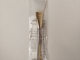 a bag of toothbrushes and a tube of toothpaste on a table