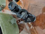 a pair of binoculars sitting on top of a wooden table