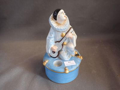 a figurine of a man sitting on top of a blue box