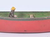 a red boat with a man sitting in it