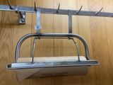 a metal rack with a paper towel holder attached to it
