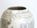 a white and blue vase sitting on a table