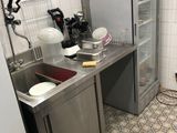 a small kitchen with a refrigerator and a sink in it