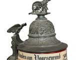 a beer mug that has a statue on top of it
