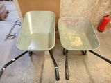 two wheelbarrows sitting next to each other on the floor