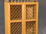 a small wooden cabinet with glass doors on a gray surface