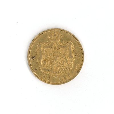 a close up of a gold coin on a white surface
