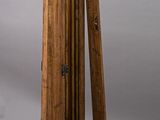 an image of a tall wooden object with a wooden base