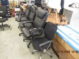 many office chairs that are lined up in a room