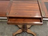 a small wooden table with a drawer on top of it