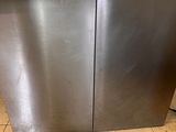 a stainless steel dishwasher sitting on a tiled floor