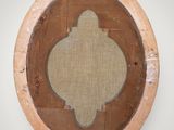 a picture of a round mirror on a wall