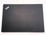a black mouse pad on a white surface with a sticker on it