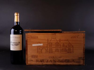 two bottles of red wine and a wooden box with a drawing of a house