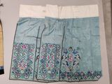 an image of a pair of blue and white embroidered skirts