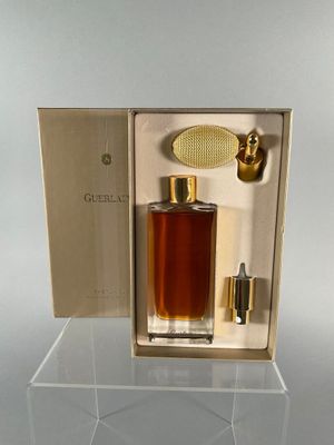 a bottle of perfume sitting in a box on a table