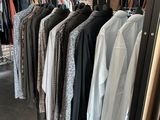 clothes hanging on a rack in a clothing store