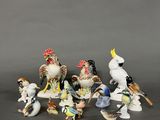 many figurines of birds sitting on a table