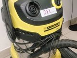 a yellow and black vacuum sitting on a tiled floor