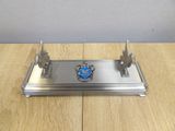 a metal stand with a blue emblem on it