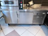 a stainless steel counter with a microwave and oven on it