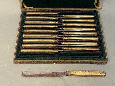 a box with a knife and eight knives in it
