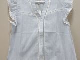blue and white striped shirt with ruffles on a hanger