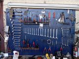 many tools hanging on the wall in the garage