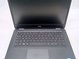a laptop with a keyboard on it sitting on a table