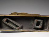 a metal box with two metal items inside of it