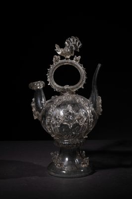 an antique silver teapot on a black background with a black background