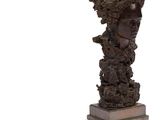 une image représentant une statue d'une femme dont la tête est une fleur