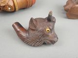 a small animal figurine on a table next to other figurines