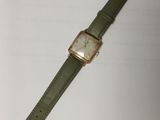 a close up of a wrist watch on a white surface
