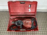 a red tool box with a hammer inside of it